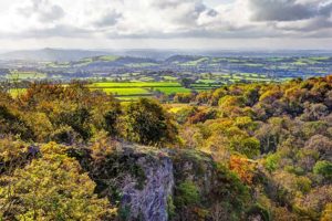 ebbor gorge view from ebbor rock of the somerset levels and glastonbury tor in the mist with a